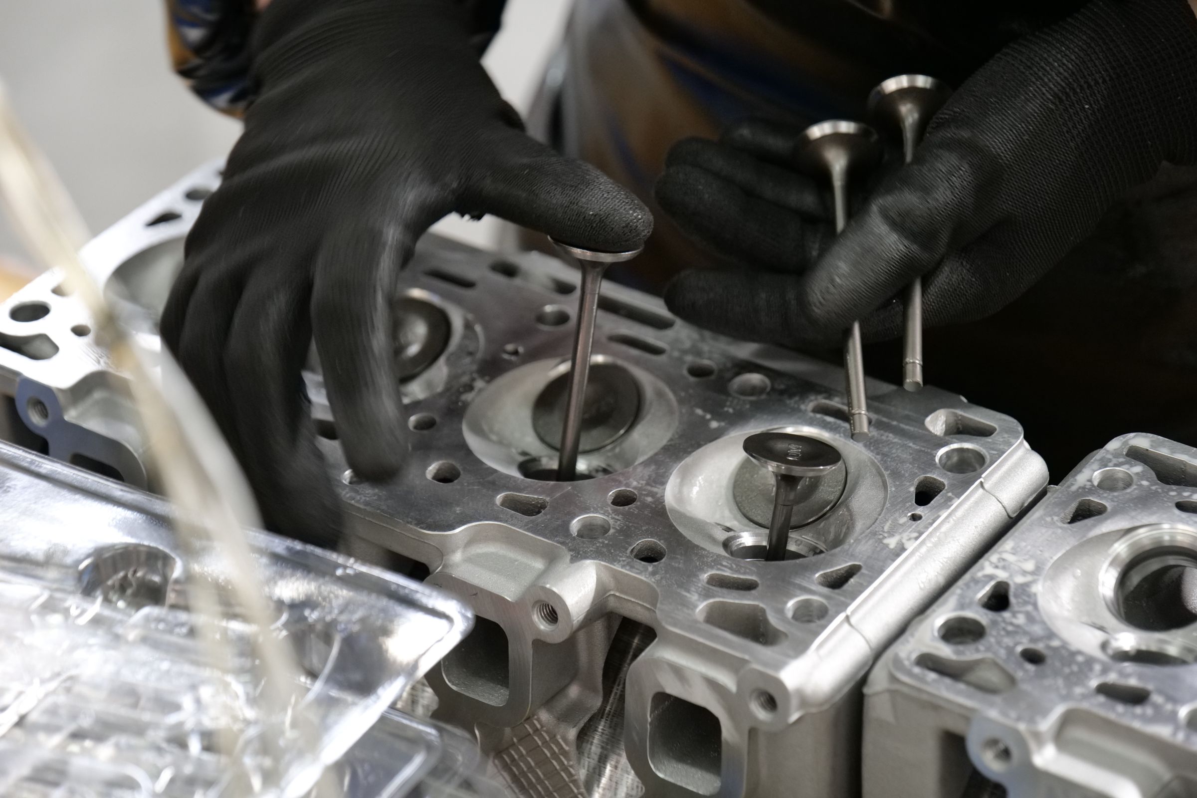 A technician working on an engine cylinder head